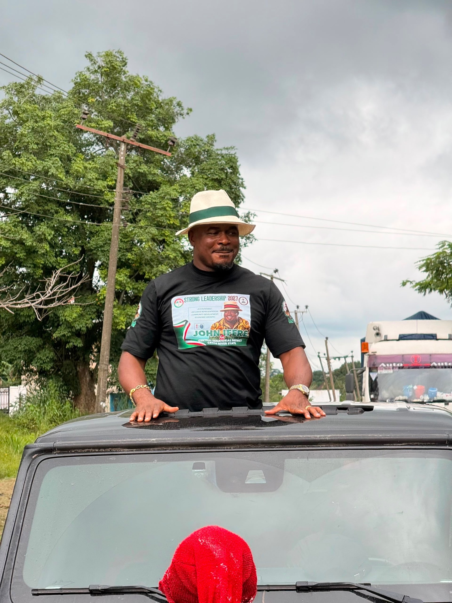 John Ifere greeting supporters from a vehicle sunroof